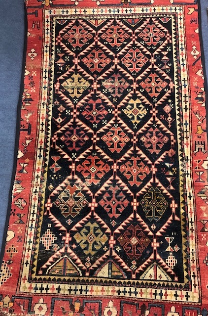 A Caucasian blue ground rug 157 x 88cm